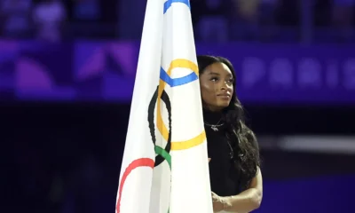 Simone Biles Carries the Olympic Flag During Paris Closing Ceremony as Olympics Transition to Los Angeles ...Full Details Bellow