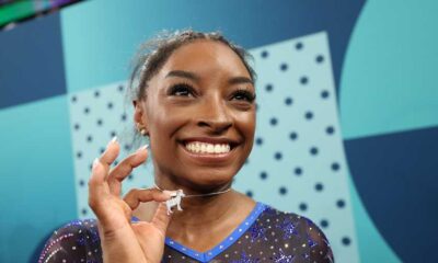 Simone Biles wears a custom goat necklace featuring 546 diamonds