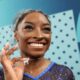 Simone Biles wears a custom goat necklace featuring 546 diamonds