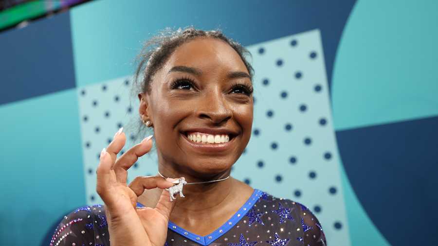 Simone Biles wears a custom goat necklace featuring 546 diamonds