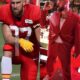 Travis Kelce Takes a Knee During National Anthem, Resulting in a Massive $10 Million Fine and Immediate Ejection from the Game