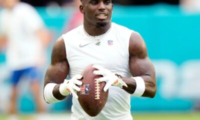 Police video shows how an officer pulled the Miami Dolphins player Tyreek Hill from his car during a traffic stop near the NFL team’s stadium.